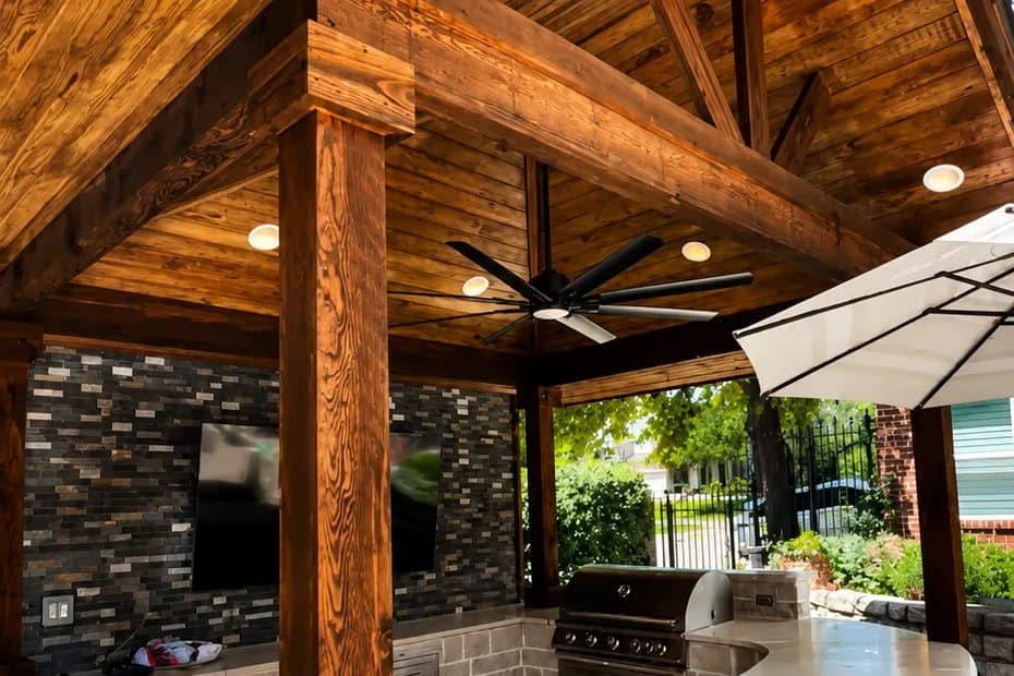 covered outdoor kitchen curved stone bar