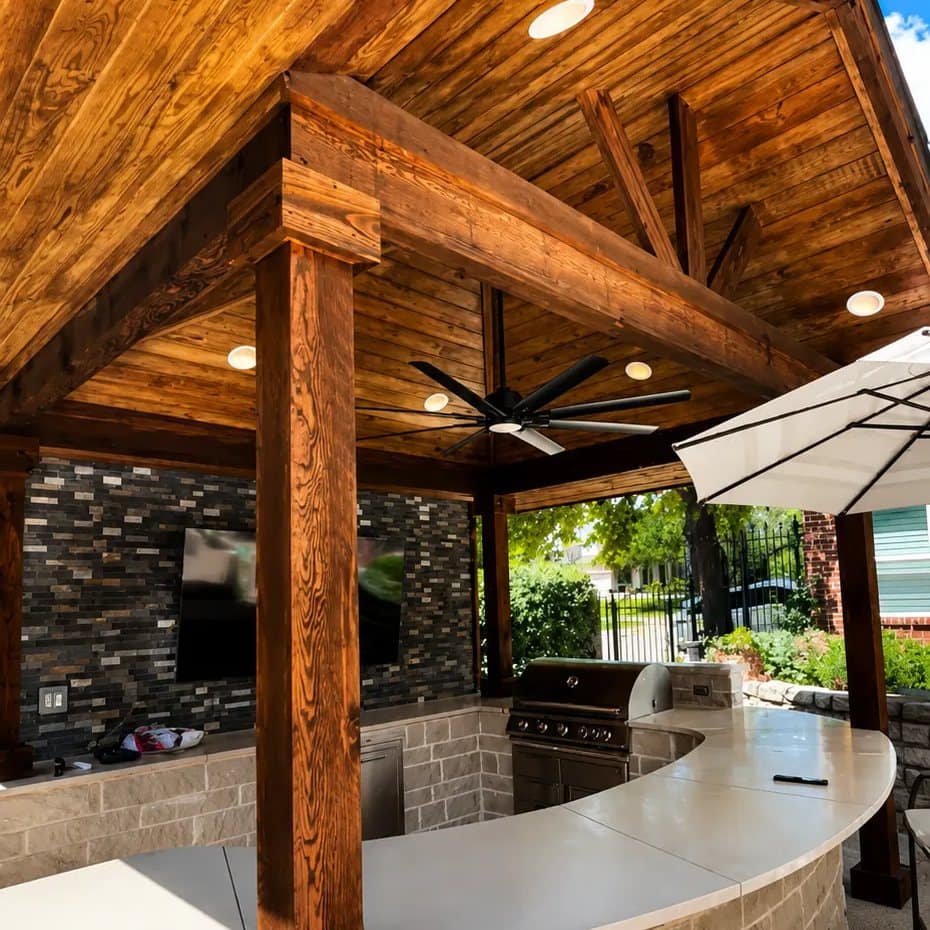 covered outdoor kitchen curved stone bar