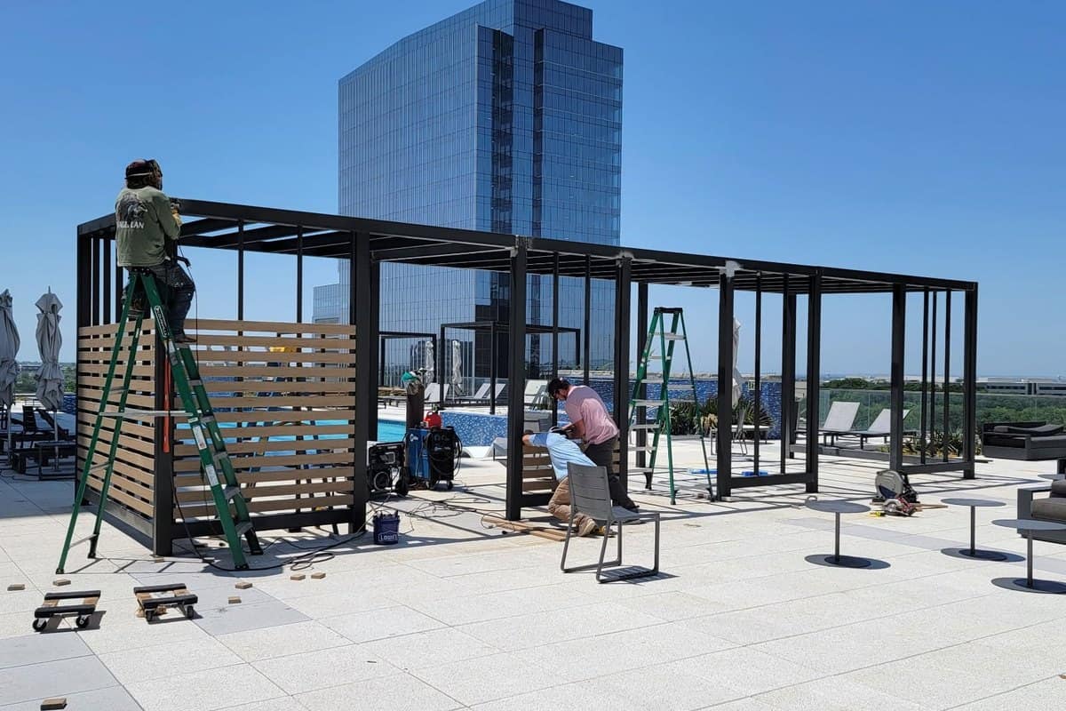 steel pergola frame rooftop crew in progress