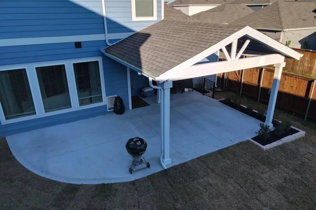 white gable patio cover aerial limestone bed