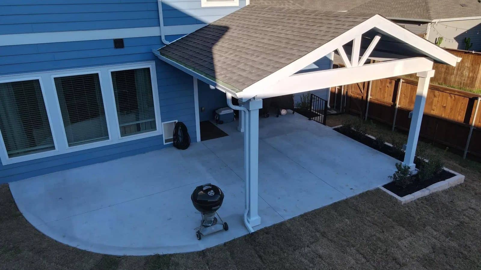 white gable patio cover aerial limestone bed